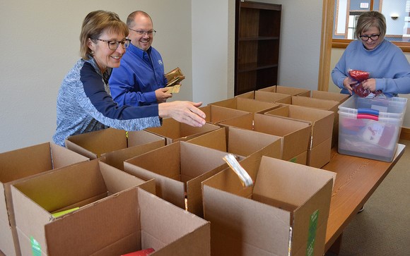 Reach Higher Montana staff assemble care packages in preparation for delivery.