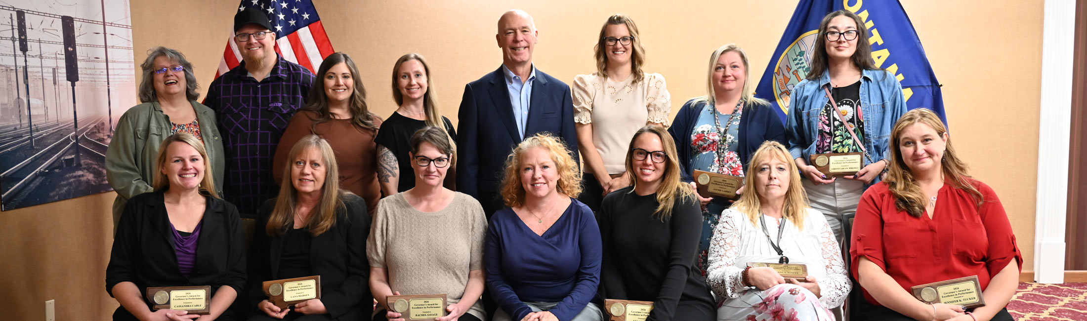 Governor Greg Gianforte and DPHHS staff members holding awards