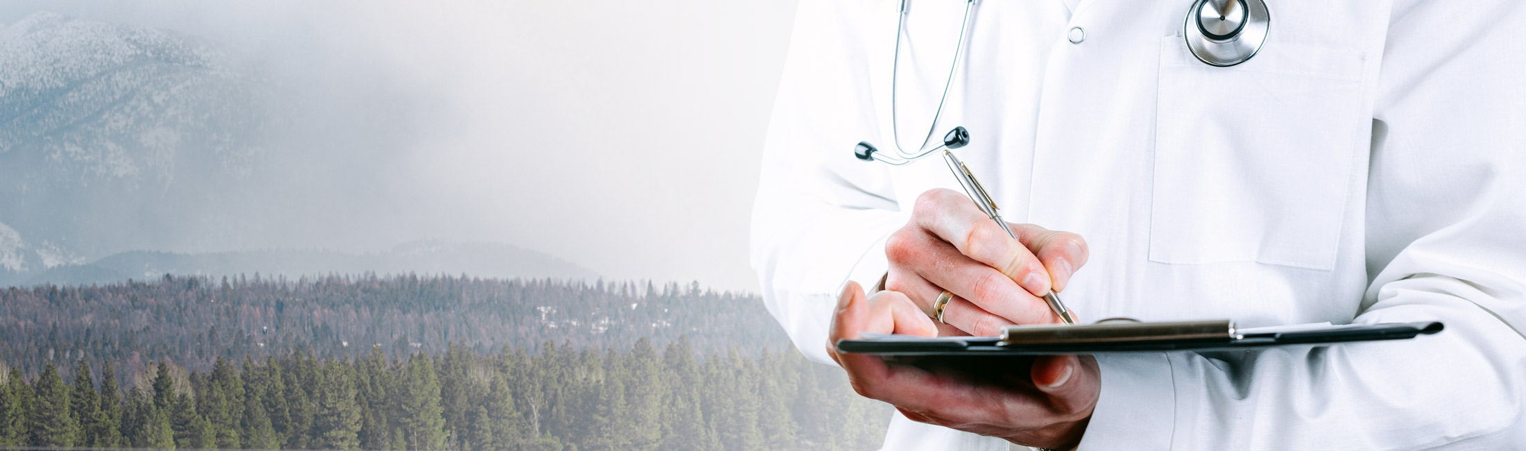man writing on clipboard wearing stethoscope