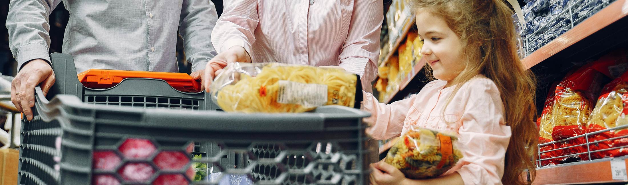 small girl shopping puts groceries in cart