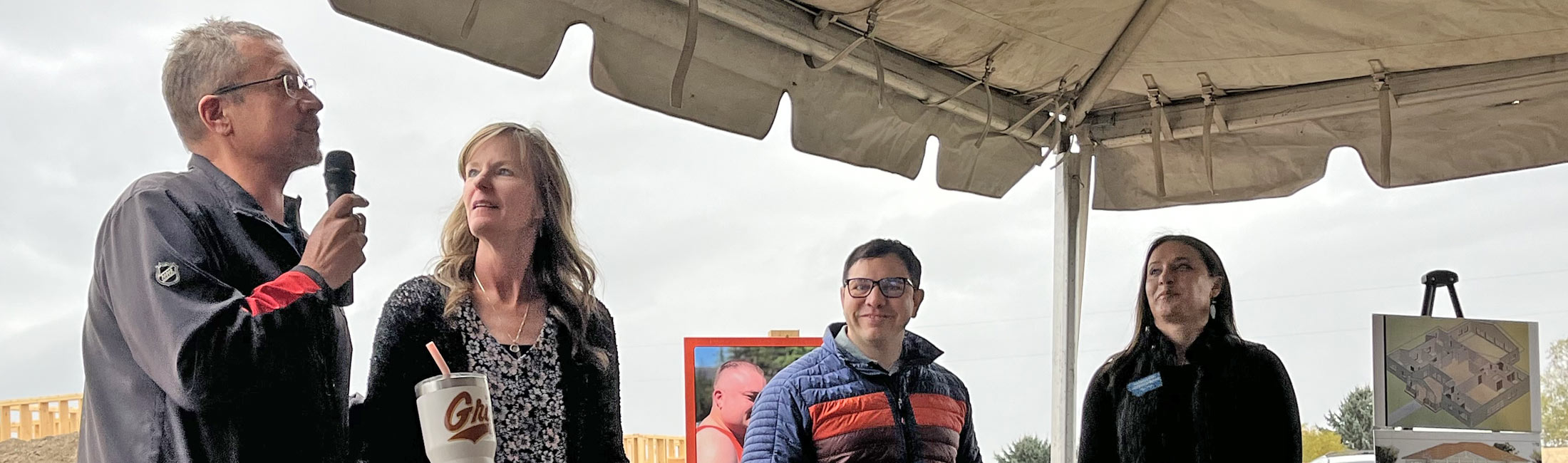 Richard Janssen, left, speaks during Monday’s event at the future site of Jake’s Farm in the Dell.