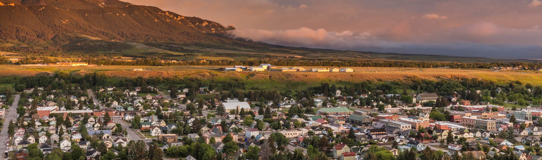 aerial view of houses next to foothills