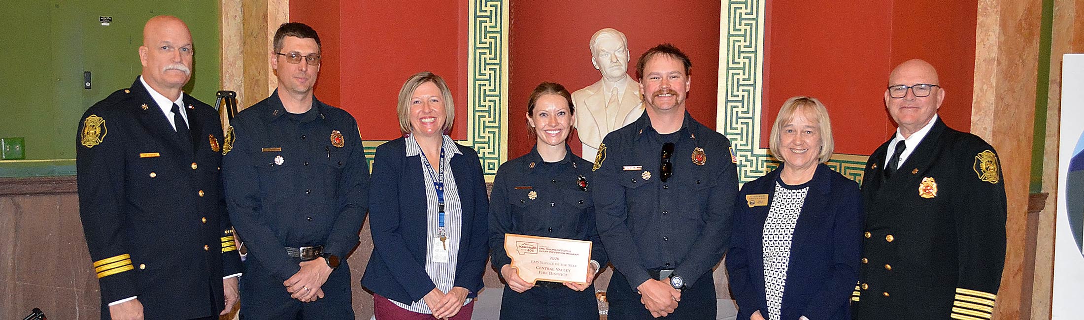 EMS responders standing holding award with Maureen Ward and Lieutenant Governor Kristen Juras