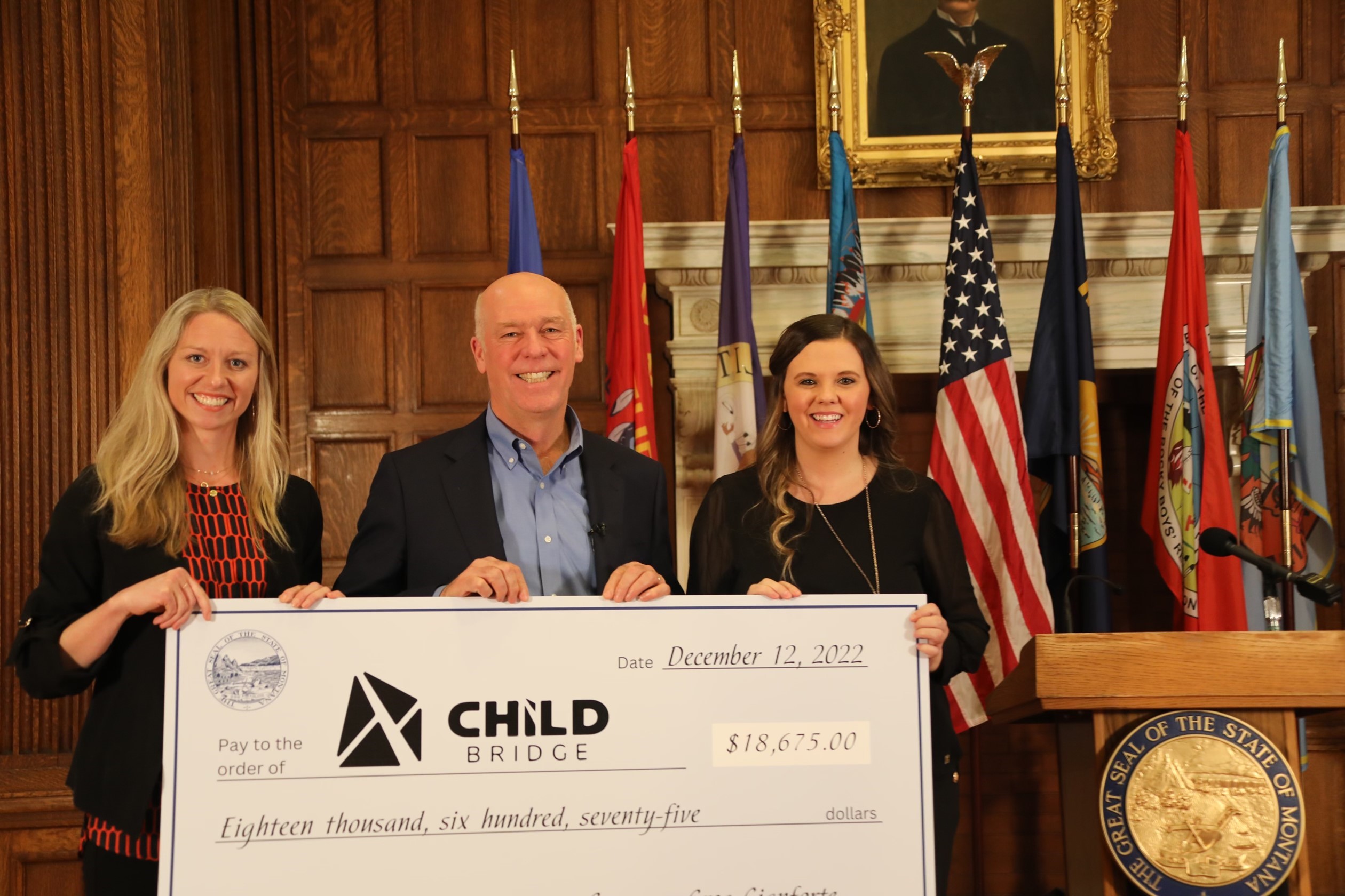 Gov. Gianforte presenting a quarter of his governor's salary to Child Bridge in the State Capitol