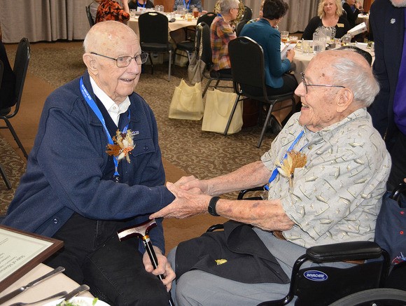 Two Centenarians shaking hands