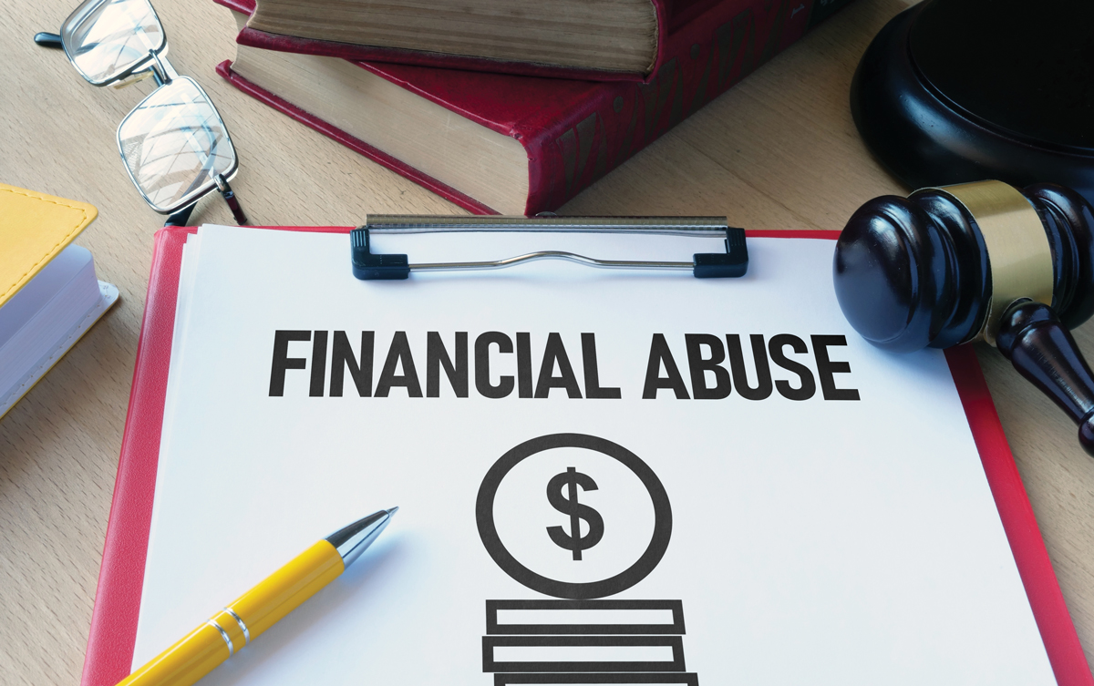 Photo of a pecil lying on a clipboard holding a paper that reads, "FINANCIAL ABUSE." A gavel sits alongside it.